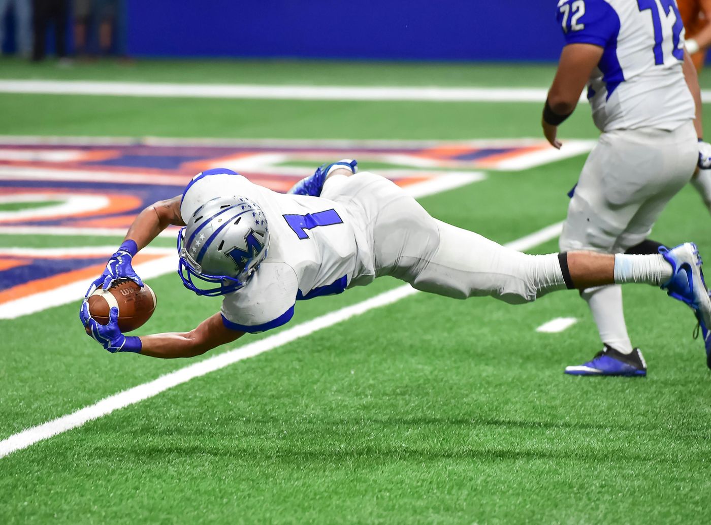 Football player making a diving catch